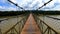 Motorcycle ridding on suspension iron cable bridge with amazing view