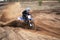 Motorcycle rider bogged down in loose sand cornering