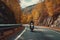 Motorcycle Rider Cruising Along Alpine Road. AI