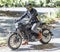 Motorcycle rider on custom made scrambler style cafe racer in th