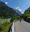 Motorcycle rider enjoys a ride on the curving mountain roads in the idyllic Swiss Alps