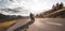 Motorcycle rider on the mountain road, wide format