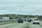 Motorcycle riders passing slower moving traffic by riding a motorcycle in the gap between two parallel lanes of traffic heading in