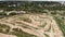 Motorcycle riders ride on sandy ground in motocross professional racetrack. Extreme sports motorbike track