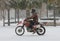 Motorcycle riding in a snowstorm down King Street