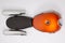 Motorcycle tank orange with black seat and chrome silver mufflers exhaust part motorbike in flat lay top view