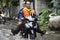 Motorcycle Taxis and volunteer carrying people passed flood on the road go to Bang pai temple