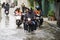 Motorcycle Taxis and volunteer carrying people passed flood on the road go to Bang pai temple