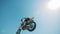 A motorcycler is flying over on his bike after jumping