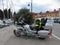 Motorcycles with lighted lights stand in line with stones paved in the coastal town of Croatia, right next to the Adriatic Sea.In