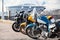 Motorcycles two wheels vehicles standing on parking lot, blue, yellow and black colors