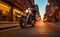 A motorcyclist on a chopper motorcycle rides down a New York street in the evening light