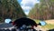 A motorcyclist drives on a bike on a country road.