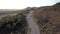 Motorcyclist driving his motorbike on the mountain road in the country side. Aerial view.