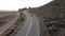 Motorcyclist driving his motorbike on the mountain road in the country side. Aerial view.