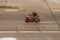 Motorcyclist driving on red motorcycle on the city street. Biker on red sport bike riding on empty street with motion blur effect