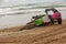 Motorcyclist fell on a motorcycle on the beach against the backdrop of the sea