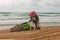 Motorcyclist fell on a motorcycle on the beach against the backdrop of the sea