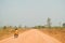 Motorcyclist Giving Ride to Young Monk on Rural Road