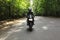 Motorcyclist goes on road, front view