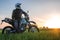 Motorcyclist on green grass off road, enduro, extreme sport, active lifestyle, adventure touring concept, enduro outdoor
