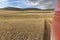 Motorcyclist in a helmet follows the car by motorbike. Mountain Altai, hills of Mongolia