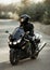 Motorcyclist in a helmet on a motorcycle on a country road. Guy driving a bike during a trip. Riding a modern sports motorcycle on