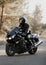 Motorcyclist in a helmet on a motorcycle on a country road. Guy driving a bike during a trip. Riding a modern sports motorcycle on