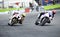 Motorcyclist overtaking another one on a bend during motorcycle racing