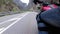 Motorcyclist Rides along on the Scenic Mountain Curve Road. Side view. POV.