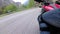 Motorcyclist Rides along on the Scenic Mountain Curve Road. Side view. POV.