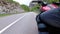 Motorcyclist Rides along on the Scenic Mountain Curve Road. Side view. POV.