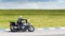 Motorcyclist rides on a country road