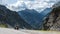 The motorcyclist stopped at the side of the road. Against the backdrop of the mountain, the Italian Alps