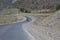 Motorcyclist is traveling by motorcycle on a winding mountain road in summer