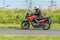 Motorcyclists on a motorcycle goes on a country road. Motion blur