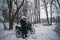 Motorcyclists puts on gloves. extreme winter riding on a motorcycle, snowy forest, snowfall. The concept of transport and clothing