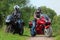 Motorcyclists standing on road looks on each other