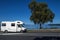 A motorhome driving along the coast of Lake Taupo in North Island of New Zealand