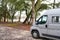 Motorhome at lac d`hourtin under the pine trees of the forest in vanlife concept camper van