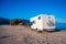 Motorhome  parked in public parking on beach in Paleochora