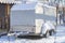 Motorhome RV  trailer  campervan parked near house under snow in winter