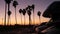 Motorhome trailer, caravan for road trip, palm trees, California beach at sunset