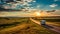 Motorhome Travelling On Highway: A Sunset Journey Through North Dakota Prairie