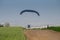 Motorised paraglider flying close to the ground