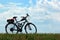 Motorized bicycle on green grass against blue sky