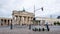 Motorized Electric Scooters At Brandenburg Gate In Berlin, Germany In Summer