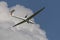 Motorized glider in a blue cloudy sky