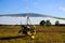 Motorized gliders stand on the ground against of a blue sky