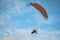 The motorized hang glider in the blue sky